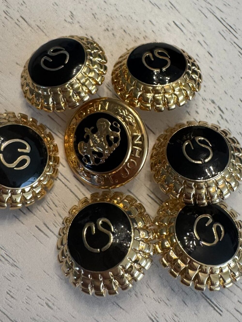 Vintage St John gold-tone/black enamel logo buttons (6), 1 with lion (7)